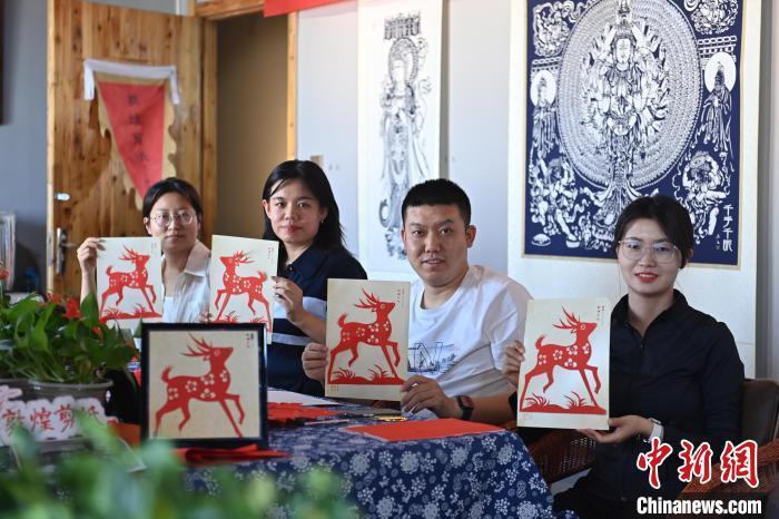 6月6日，在甘肅敦煌青年夜校課程中，青年學(xué)員展示學(xué)習(xí)敦煌非遺剪紙的成果。李亞龍 攝　　
